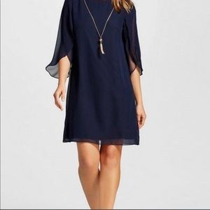 NWT navy dress with sheer petal sleeves and gold chain detail